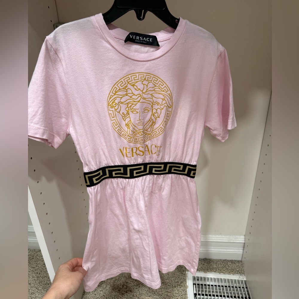 Versace dress for girls. Size is 4T. The color is pink with black and gold.